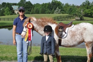Ashley Schneider and Caramel Topping showing off their Reserve Champion ribbon.